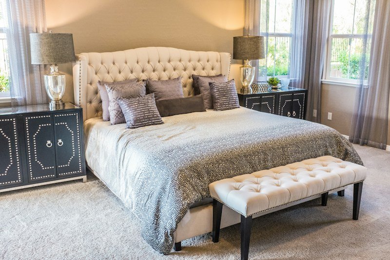 Upholstered bedroom set with tufted headboard and matching bedside tables