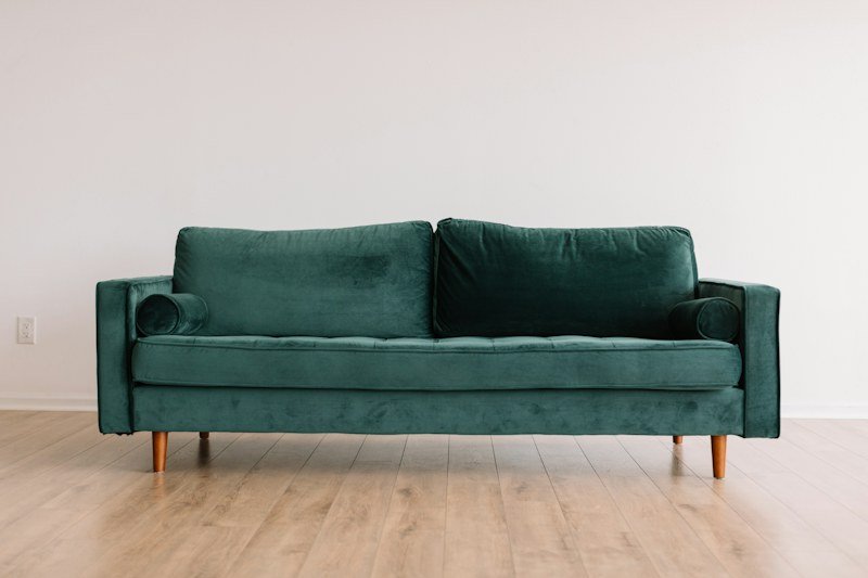 Deep green upholstered living-room sofa